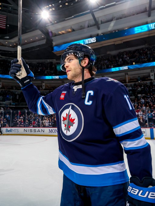 Adam Lowry #17 of the Winnipeg Jets salutes the fans following a 3-1 victory over the St. Louis Blues for a franchise record 53rd victory on the season at Canada Life Centre on April 07, 2025 in Winnipeg, Manitoba, Canada. (Photo by Jonathan Kozub/NHLI via Getty Images)