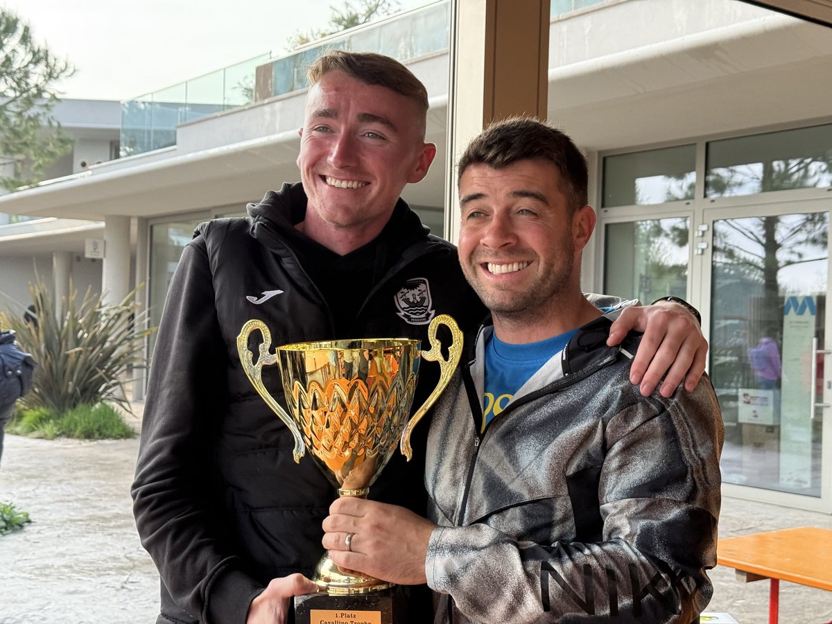 Boys and coaches collecting their winners trophy 🏆
