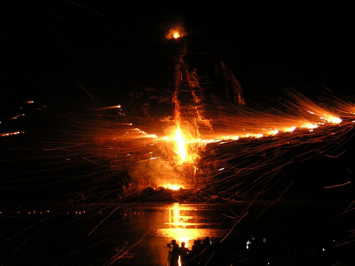A fire festival in S. Korea where sparklers are strung across a river and on the other side, guys heave burning logs off the top of a cliff.