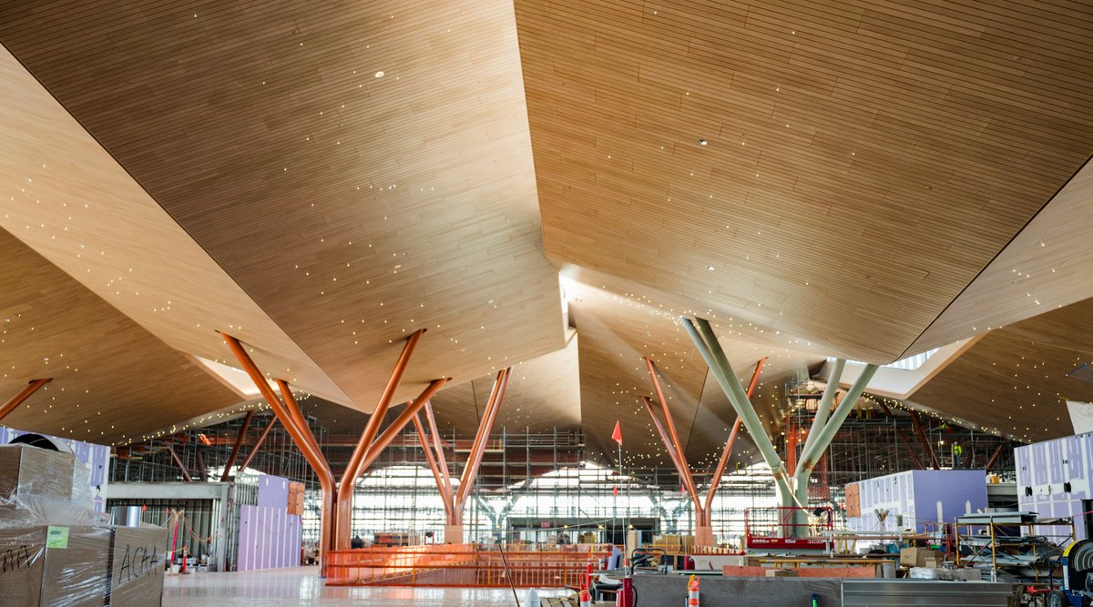 PITairport's tweet photo. Look how far we've come! These were taken a year apart on the departures level of our new terminal 🤩

The terminal's ceiling and lighting mirror Western PA's rolling hills and starry skies, while the region’s forests inspire the tree columns 🌳 ✨ https://t.co/V84jrnPYri