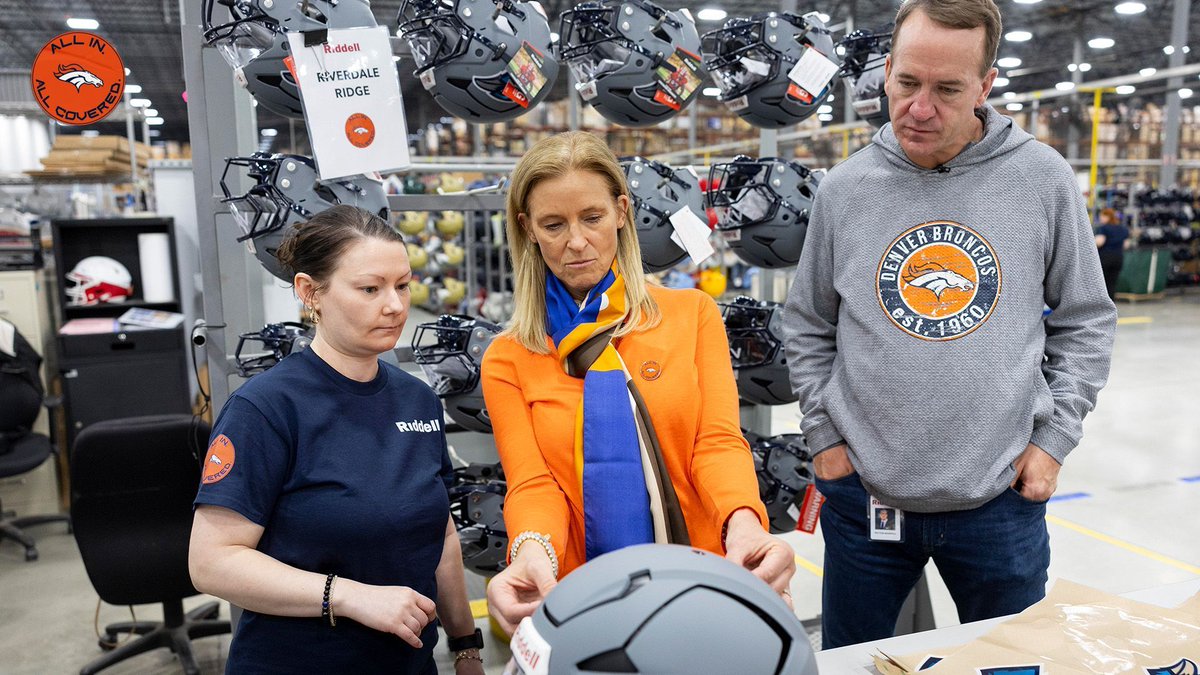 Broncos's tweet photo. Our ALL IN. ALL COVERED. helmets are officially in production. 👀

Owner &amp; Foundation Board Chair Carrie Walton Penner &amp; @RiddellSports Ambassador Peyton Manning stopped by the Riddell Factory in Ohio today to see some of the first Colorado high school helmets being made. https://t.co/4AYwb3NNKN