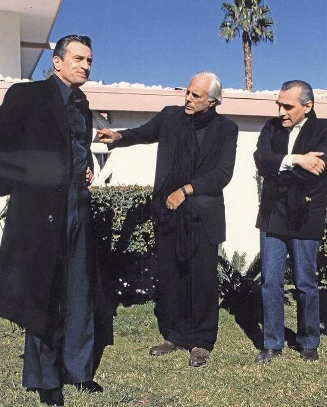 Giorgio Armani inspecting Robert De Niro's wardrobe with Martin Scorsese on the set of Casino, 1995