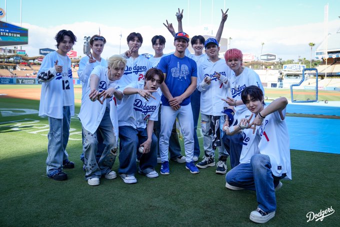 A photo of TREASURE with Tommy Edman on the field at Dodger Stadium.