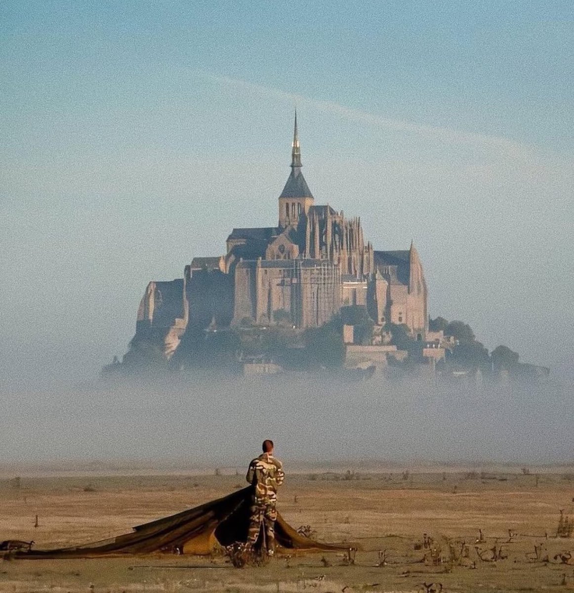 A French Navy Commando gathers his parachute after a training jump near Mont Saint-Michel