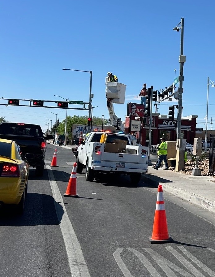 abqdmd's tweet photo. We're installing the first PAWS lights on Central near Louisiana. Our clever engineers trained cameras to use AI to track pedestrians who are crossing the street. When someone attempts to cross Central, watch for the flashing lights. #DMDBuilds #DMDinvents https://t.co/15jl0WtX5A