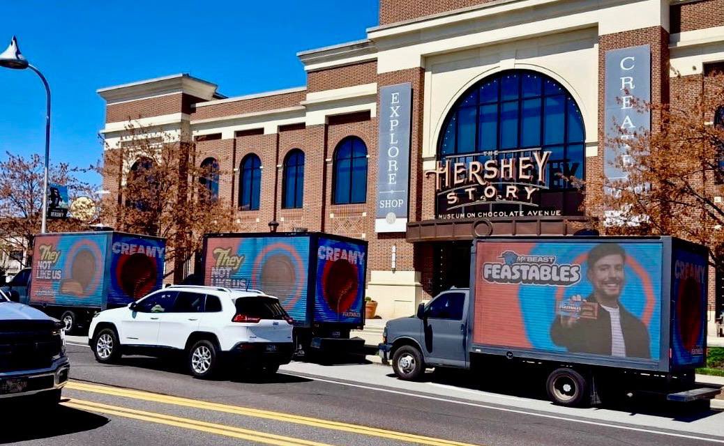 MrBeast's tweet image. An army of trucks advertising Feastables are currently driving around Hershey’s city