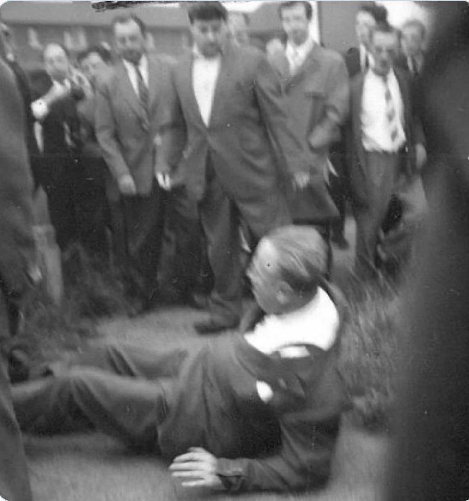 Oswald Mosley knocked to the ground by anti-fascists in Manchester on July 29, 1962. He was escorted away by police while being pelted with eggs and stones.