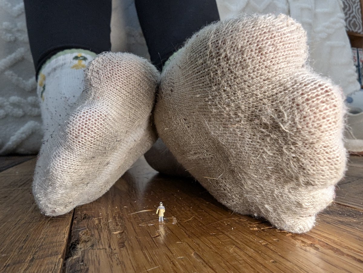 This giantess is ready to play using her socked soles!