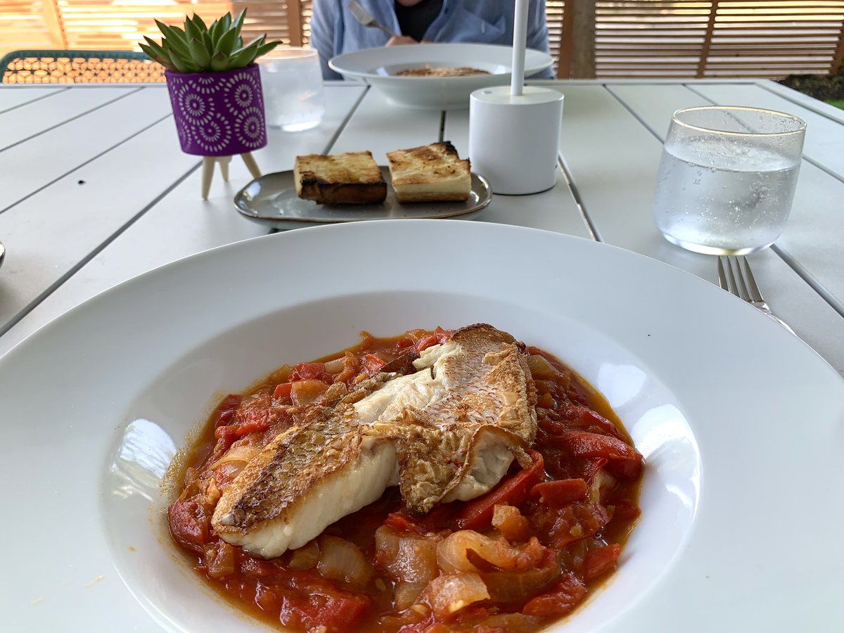 Dinner on the patio (while we still can). Sautéed red snapper filets over piperade; grilled olive oil bread.