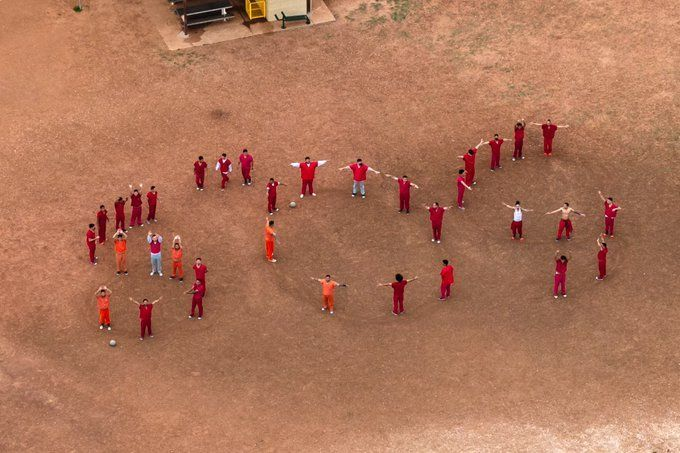 Men kidnapped by the Trump regime spell out an SOS at the Bluebonnet ICE concentration camp.