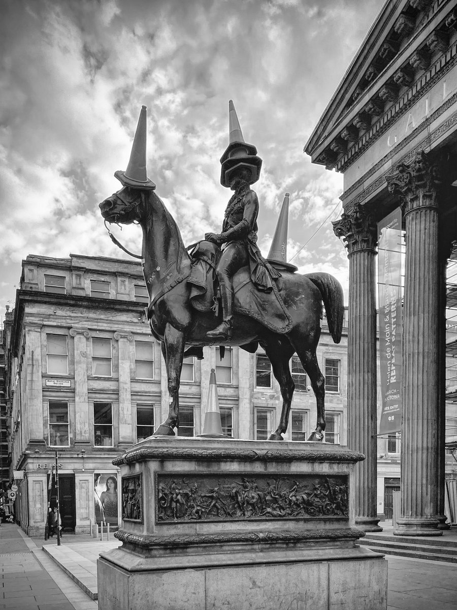 Glasgow 2023 wiki> "In front of the gallery, on the Queen Street pavement, stands an equestrian statue of the Duke of Wellington sculpted by Carlo Marochetti in 1844. The statue usually has a traffic cone on its head; for many years the authorities regularly removed cones."