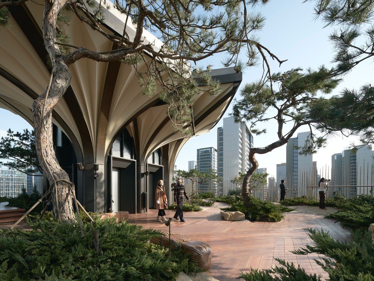 TheB1M's tweet photo. The Chinese city of Xi'an has a new neighbourhood. Designed by Heatherwick Studio and located south of the city's historic centre, the 155,000 square metre new Xi'an Centre Culture Business District (CCBD) features extensive ceramics in reference to the ancient capital's Terracotta Army and the legacy of local craftsmanship.

The new development includes a retail podium with walkable streets, terraces and open plazas, offices, apartments, accommodation and green spaces.

The streets converge at a central plaza where the Xi'an Tree, a new vertical park, creates a natural gathering point. Visitors can travel up its 56 elevated terraces (termed "petals") where a sequence of cascading gardens follows the biomes of the ancient Silk Route from the alpine tundra to the dry steppe. 

In a statement, Thomas Heatherwick, founder and design director of Heatherwick studio, said:

"We were excited to create a commercial district which gave the city an extraordinary new piece of public space. Instead of simply making different buildings, and paving and planting the spaces between them, there was the opportunity to craft an unexpected three-dimensional urban landscape on many levels, where citizens of the city can promenade and meet each other. Pursuing our interest in people’s human scale experience of places, we also had the chance to integrate many special constructional details, to help make the project as engaging as possible for people to walk around. The goal of the whole project was to find a joyful and contemporary way to respond to the history of Xi’an, and bring people together.”

Xi'an Centre Culture Business District (CCBD) opened in December 2024.

📷 Heatherwick Studio