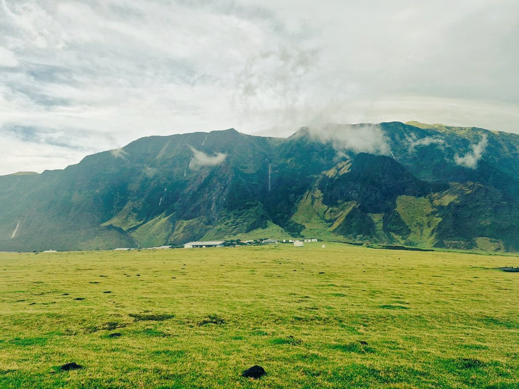After two days of heavy rain, the sun begins to peek through a soft veil of mist. The clouds rise gently, unveiling Tristan’s majestic mountain—now laced with silver ribbons of waterfalls, tumbling down like nature’s own applause. A breathtaking sight after the storm’s embrace