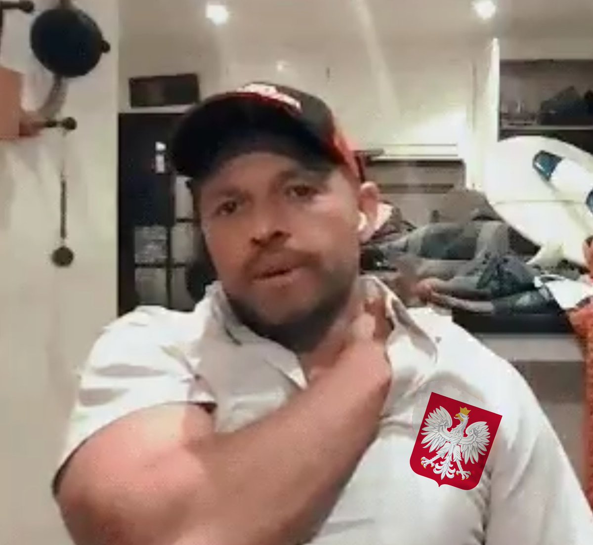 It's the way he looks here like a typical Polish football hooligan Michał, and I always think he's wearing a Polish national team shirt.