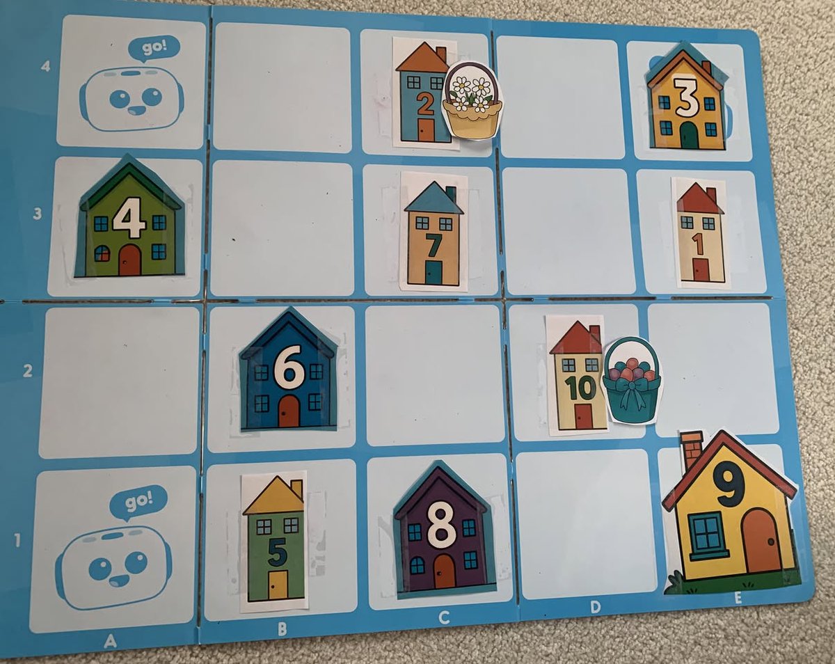 Happy May Day! Tale-Bot is zipping around delivering May baskets to houses. The younger child was tasked to find the house with a specific number. The older child was challenged to solve an addition or subtraction puzzle, then deliver the basket to the house with that answer.