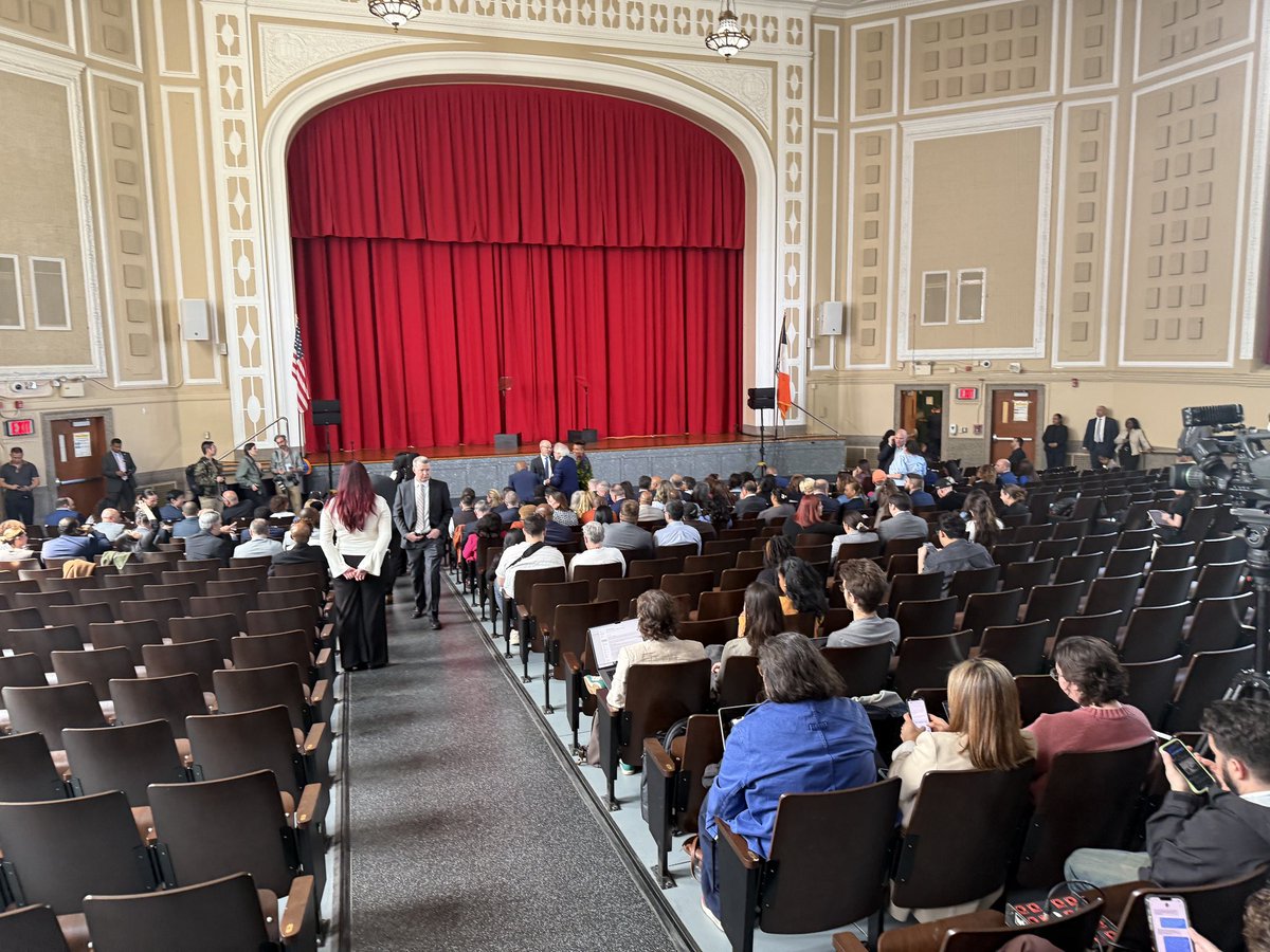 Sparse attendance for “Best Budget Ever” announcement with people being asked to move up to fill front rows, seemingly for the cameras