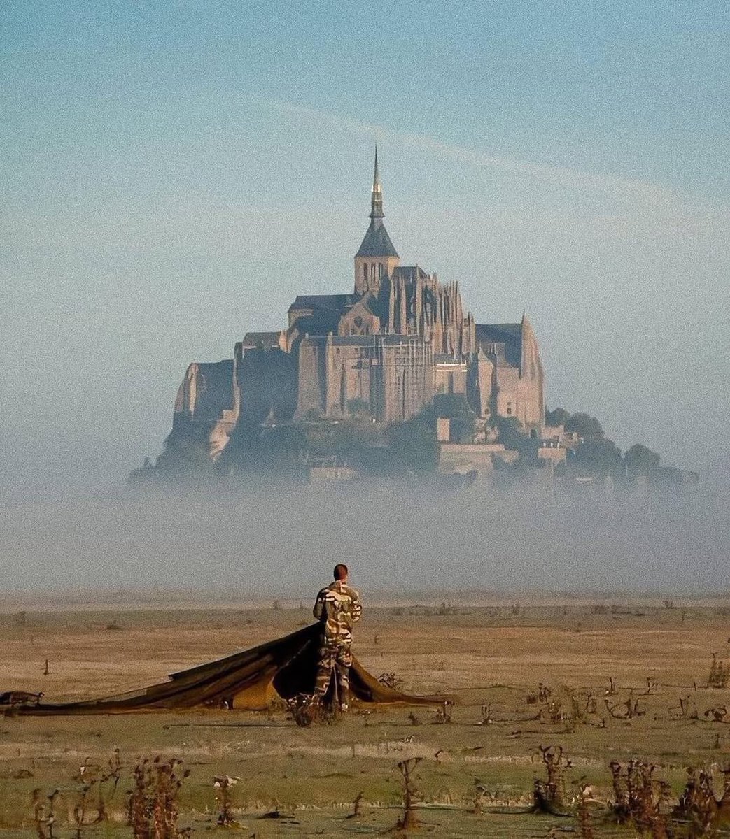 a french navy commando gathers his parachute after a training jump near mont-saint-michel