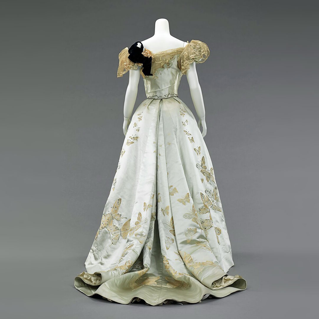 Ball gown designed by Jean-Philippe Worth, 1898.
Bespoke fabric was woven with meticulous placement to perfectly conform to the contours and measurements of the skirt. The featured butterflies delicately ascend from the hem and, varying in size, appear to fade into the distance.