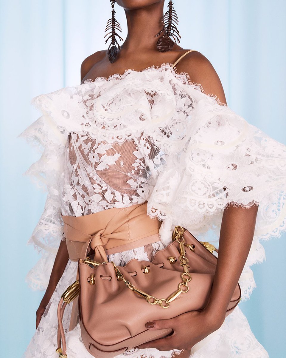 Tiers of ruffled lace bring movement and texture to Spring 25.​

The Dawning Lace Mini Dress styled with the Halcyon Clutch. Discover Spring 25 &gt; with-zim.com/X-spring-25