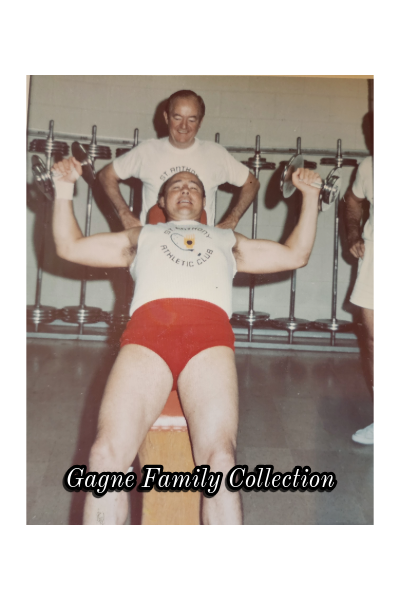 Verne Gagne (White shirt/Red Trunks) is working out and having a little fun with Hubert H. Humphrey. Humphrey was a Mayor of Minneapolis, MN, later represented Minnesota as a U.S. Senator and was the Vice President of the United States under the Lyndon Johnson administartion.