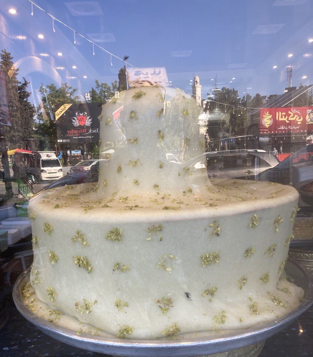A castle of clotted cream? In #Homs, post-war reconstruction has barely begun, but the city patissiers build their famous halawet el jibn delicacy sturdily and high from a mixture of semolina and cheese حمص#