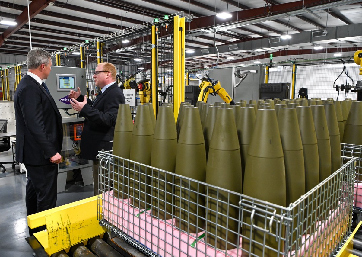 ColbyBadhwar's tweet photo. 🇺🇸💥155mm production update💥

Yesterday, General Dynamics Ordnance & Tactical Systems opened their new 155mm Load, Assemble & Pack (LAP) facility in Camden, AR. 

Once fully operational it will have a monthly production capacity of 50,000 rounds per month, a full half of the US Army's 100,000/month target. 

The other 50,000 rounds of capacity is coming from the Government Owned, Contractor Operated (DayZimm/AO) Iowa Army Ammunition Plant, and their Contractor Owned, Contractor Operated Parsons, KS facility, which was formerly the GOCO Kansas Army Ammunition Plant. 

The plant has two production lines, one is facilitized to LAP M795s at a rate of 20,000/month, and the other M1128s at 30,000/month. 

LAP is the final stage of the production process for munitions, where metal projectile bodies are filled with explosive material, assembled with other components, and packed for shipment.