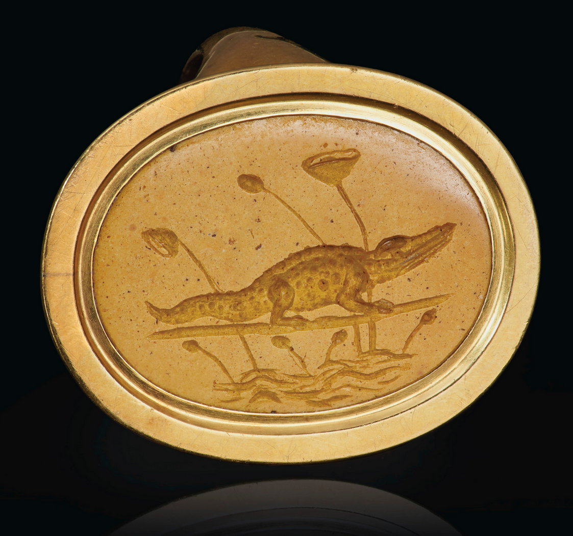 archaeologyart's tweet photo. A Greek yellow jasper ringstone engraved with a crocodile, from Alexandria, Hellenistic period, circa 2nd–1st century BC. Private Collection. https://t.co/lzUsSBJiIo