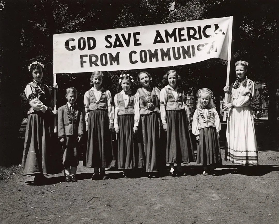"God save America from communism"

Title and photo by V. Gravitis Photo Studio with children in Latvian folk costumes. Boston, Massachusetts, circa 1950.