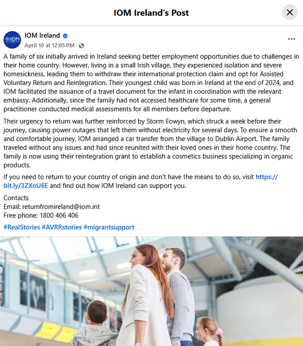 The image is a screenshot of a social media post from IOM Ireland, featuring a family of six. The family is depicted in a typical family portrait setting, likely outdoors, with a blurred background that suggests a natural or park environment. The post discusses the family's journey from seeking asylum in Ireland due to employment challenges to their decision to return home after experiencing isolation in a small Irish village. The text highlights their facilitated return by IOM, including medical assessments and travel arrangements, and mentions their new venture in organic cosmetics. The post includes contact information for IOM Ireland and hashtags like #RealStories and #AVRRstories, indicating a focus on real-life migration stories and assisted voluntary return and reintegration.