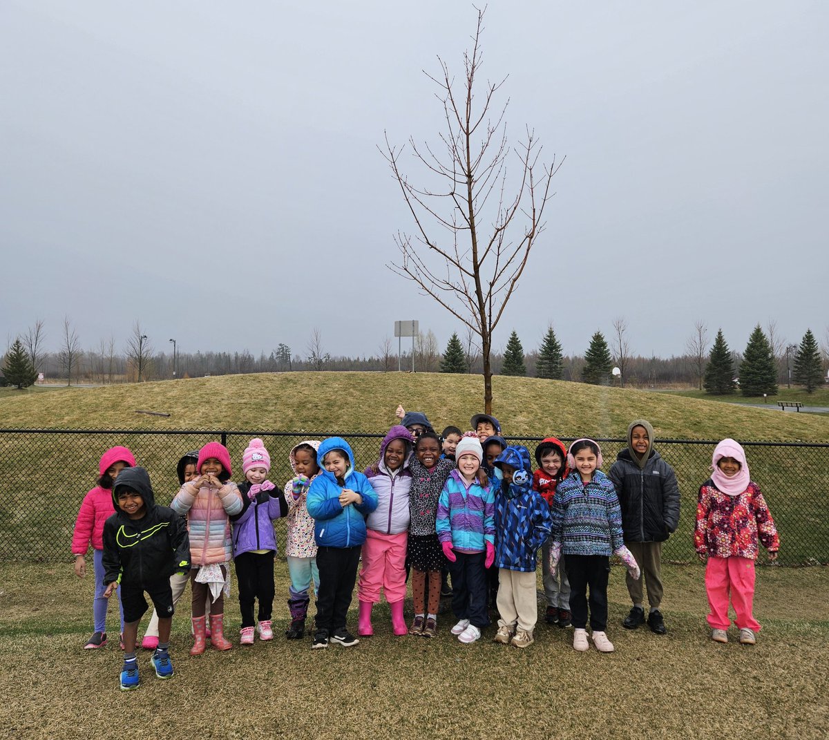 Today was Tree Day at <a href="/StVeronicaOCSB/">St. Veronica OCSB</a>! We gathered around our class tree in the pouring rain at recess, looking for signs of new growth. We think the buds will open soon with all the rain. Remember to dress for the weather, as we have Outdoor Learning every day! #ocsbEarthWeek
