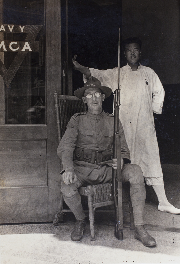 Hostel worker standing behind Floyd Tangier Smith, an American Company Shanghai Volunteer Corps member on duty at the entrance to the Navy YMCA, Shanghai, 1925

After MAY 30TH 1925

Hutchinson Family Collection
Hn06-234
hpcbristol.net/visual/Hn06-234

#shanghai #ymca #chinesehistory