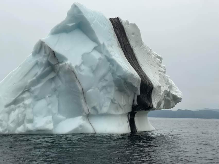 Inuk word of the day:
Ice berg - PiKalujak (Pe - ha - lu - yuck)
The black layer is from volcanic ash, this tells of one later older than the other, the ash became part of the ice build up.