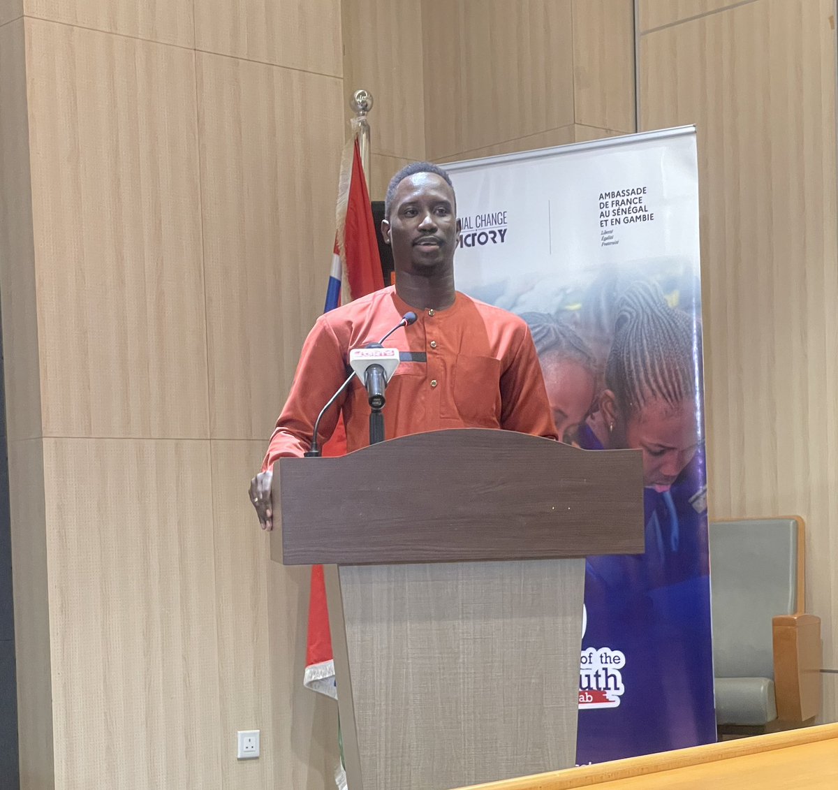 basirubj's tweet photo. I had the honor of delivering a statement on behalf of the @GambiaNYC at the National Public Audience of the Voice of the Youth Lab (VoTY Lab) a 9-month civic engagement & youth empowerment initiative implemented by #SocialChangeFactory with support French Embassy in 🇸🇳 & 🇬🇲 https://t.co/yIQOnc8WKM