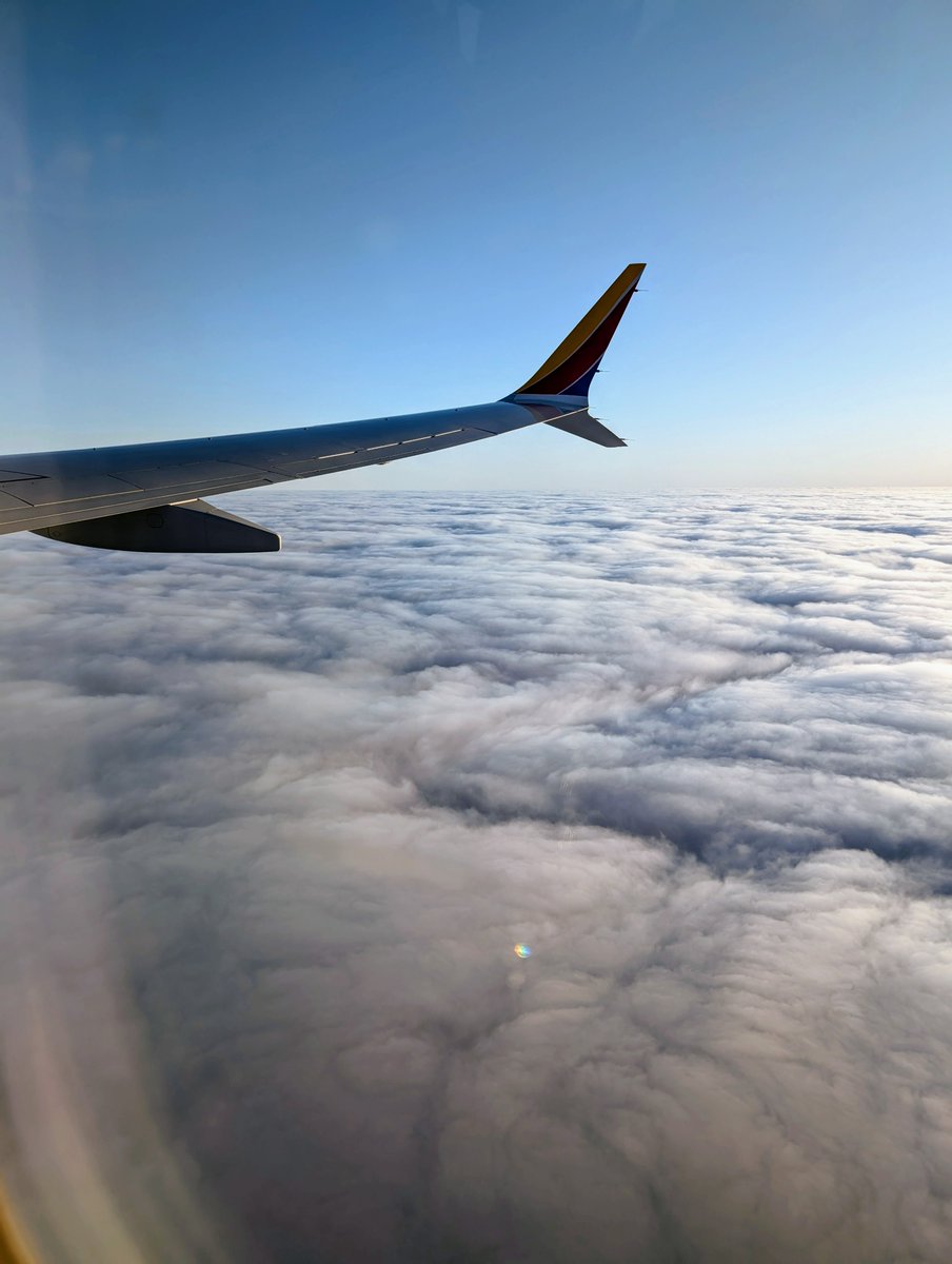 Just before landing in Chicago, above a sea of fluffy clouds. #AACR25