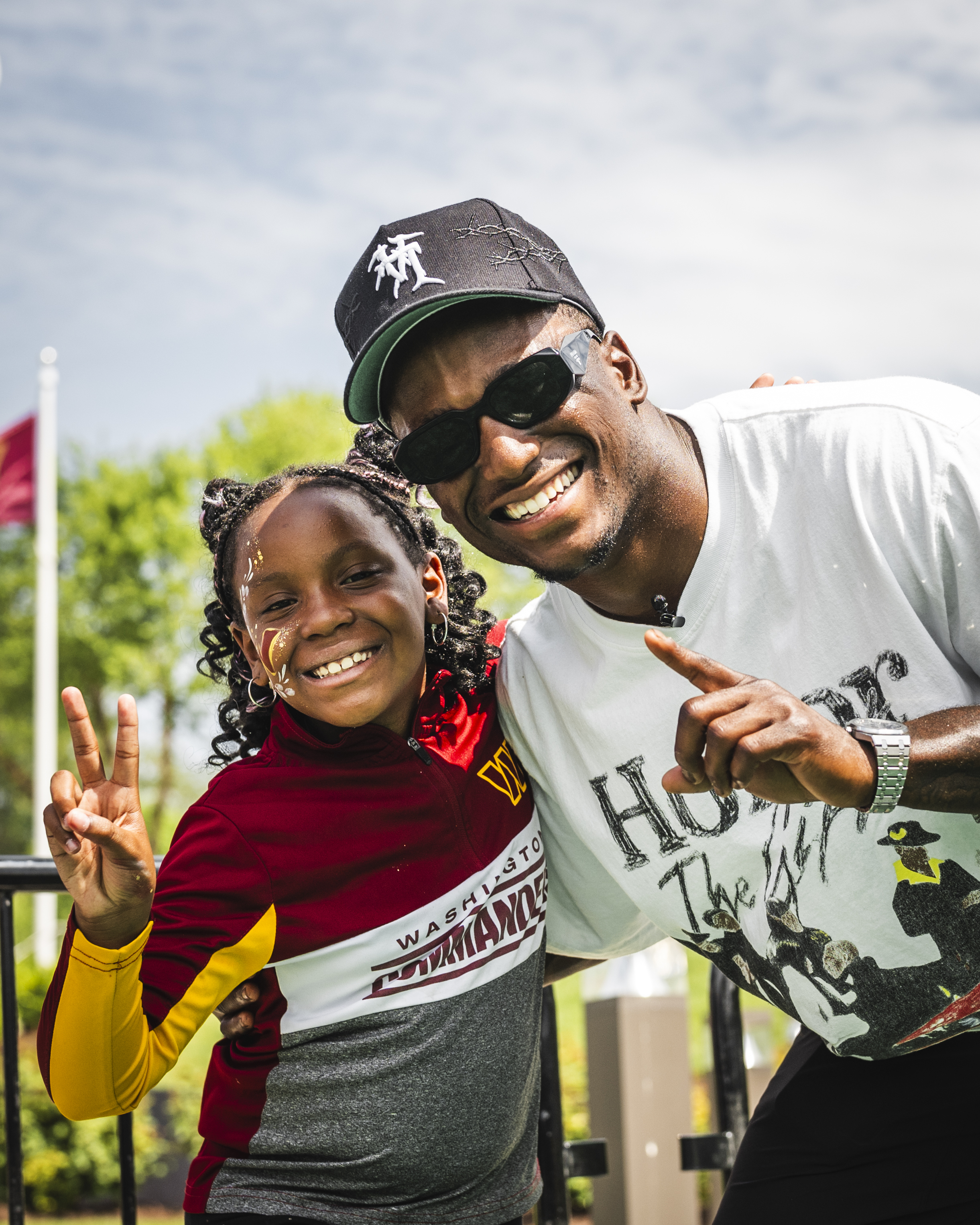 Photo from the Draft party at National Harbor. Jeremy Reaves is posing for a picture with a young fan. 