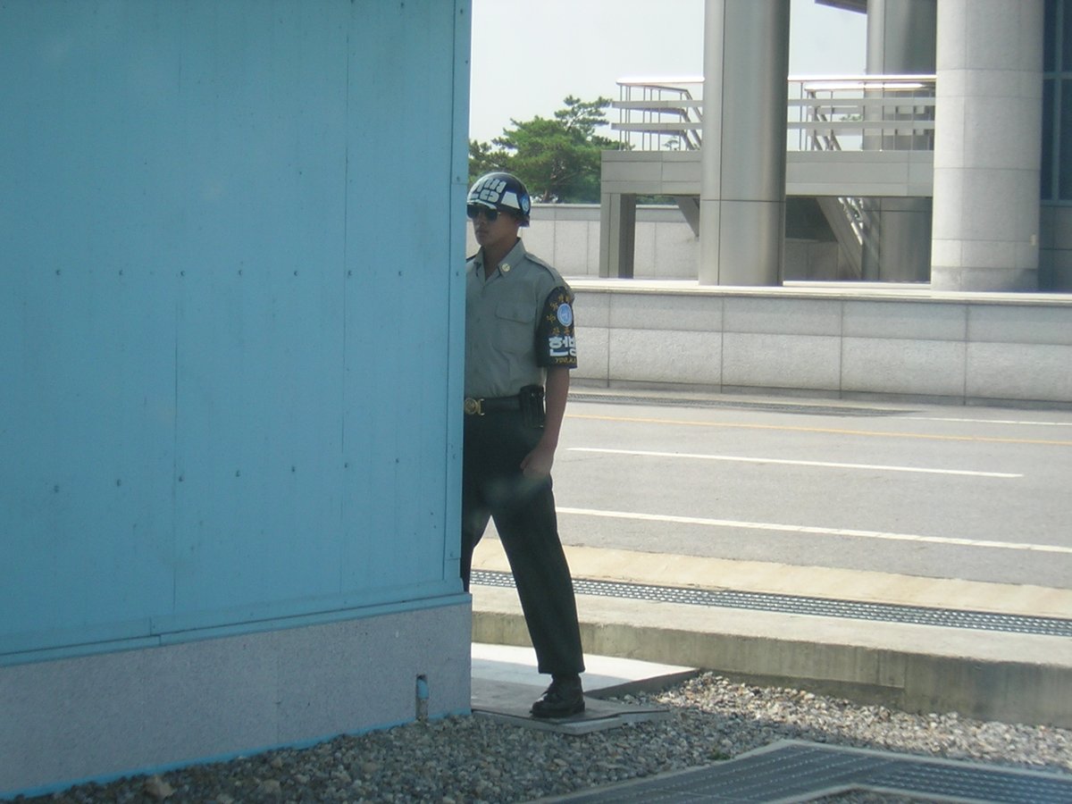 Panmunjom on the Korean DMZ. Note the S. Korean soldier with one stink eye on the Norks and keeping half of his body protected. The problem is he is right-handed and his sidearm is behind the peace talks building. A southpaw would be better suited.