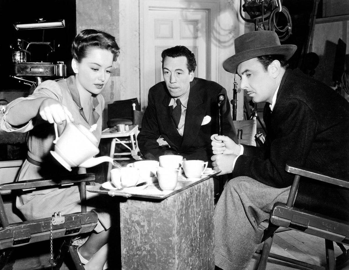 Olivia de Havilland, director John Huston and George Brent during a break from filming In This Our Life (1942)