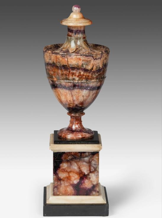 The coloration of this Derbyshire vase is known as Blue John, and comes from the French “bleu-jaune". This spectacular urn is mounted in an elegant Blue John pedestal with alabaster and black marble base and cornice.

Blue John vase, c. 1780, @thomascoulborn
#AntiqueOfTheDay