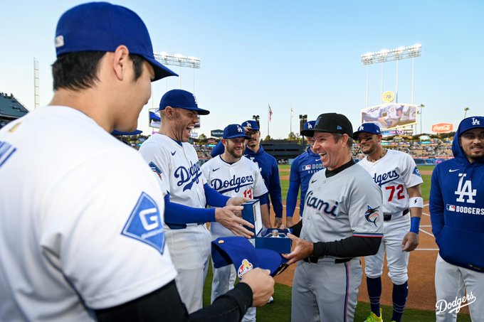 Freddie Freeman smiles while giving Clayton McCullough his World Series ring.