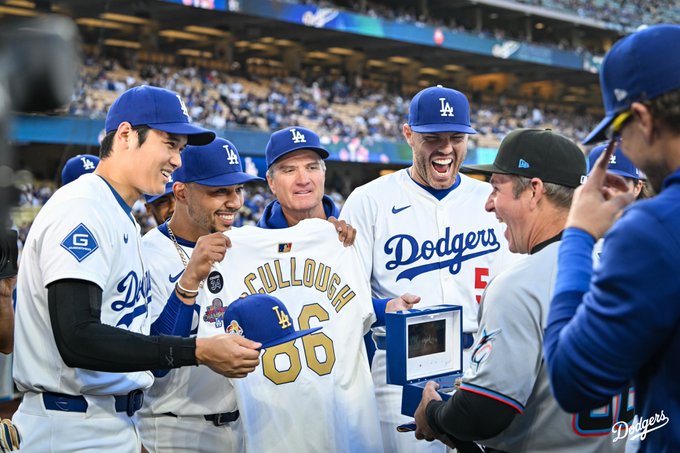 Shohei Ohtani, Mookie Betts and Freddie Freeman give Clayton McCullough the World Series ring, a gold Dodger hat and jersey.