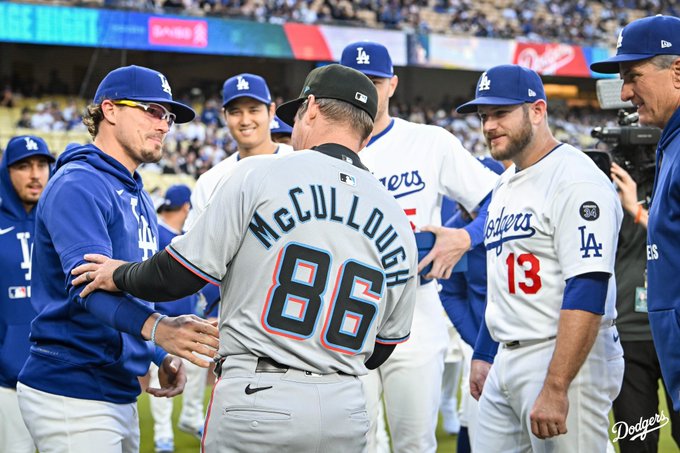 Kiké Hernández smiles and shakes Clayton McCullough's hand.