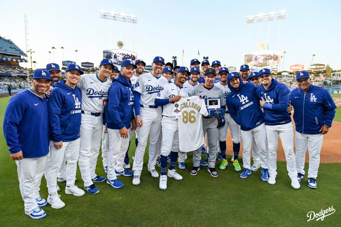 A photo of Clayton McCullough with Dodger players and coaches on the field.