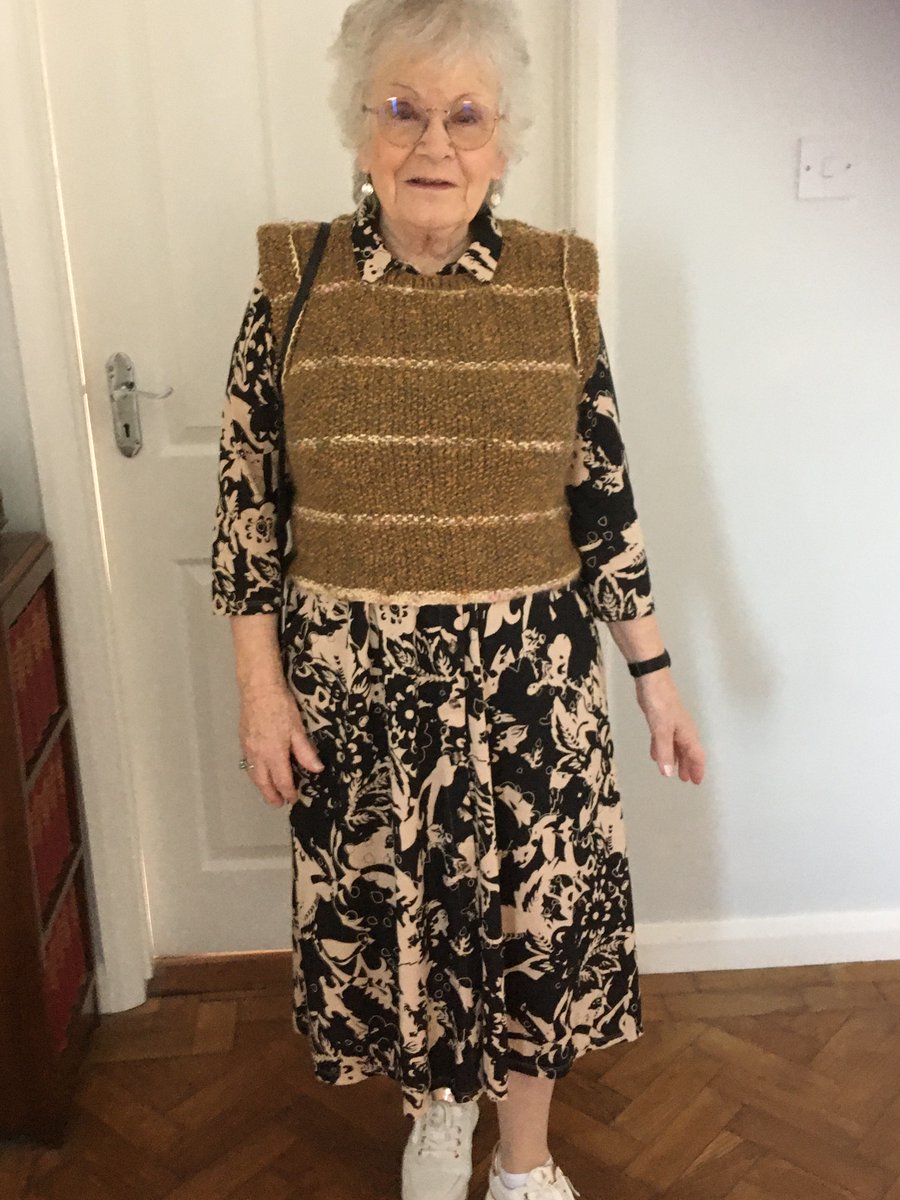 Claire Boley wearing a tank top over a  dress, it was designed, spun and knitted by Claire