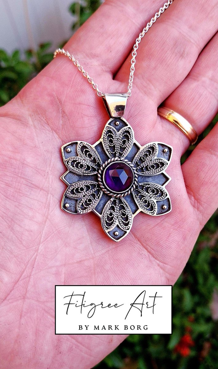 "Nightshade"
Crafted from sterling silver and set with a rose-cut amethyst, this pendant is inspired by the mysterious elegance of the nightshade flower. With its delicate filigree petals and deep violet heart.
*Available*!!
#filigreeart #MarkBorg #amethyst #malta #maltese