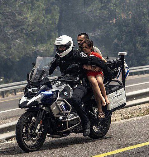 🇮🇱If one photo could sum up Israel, this would be it. 📸⬇️

An Israeli police officer rescues a father and child from the fires engulfing the outskirts of Jerusalem. 

The officer drives using one hand as he uses the other to keep the child safe. 

<a href="/Israel/">Israel ישראל</a> <a href="/IsraelMFA/">Israel Foreign Ministry</a>