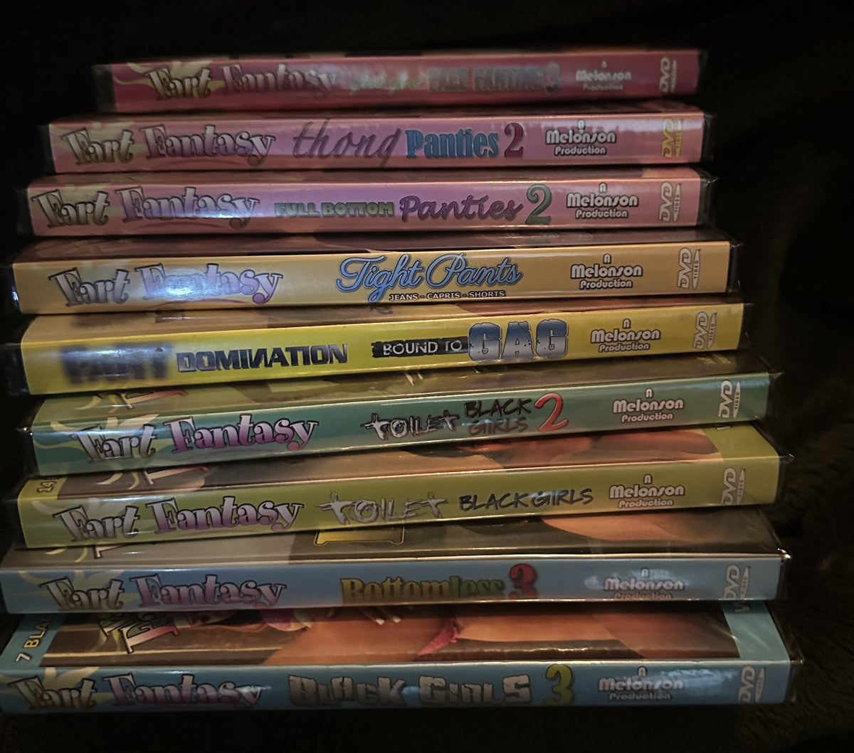 fartfantasy's tweet photo. This week's DVD pile consists of "Girl-Girl Face Farting 3", "Thong Panties 2", "Tight Pants", "FartDom: Bound to Gag", "Toilet Black Girls", "Toiet Black Girls 2", "Bottomless 3" and "Black Girls 3". - Want to Win These DVDs? See Official Rules in Replies ->