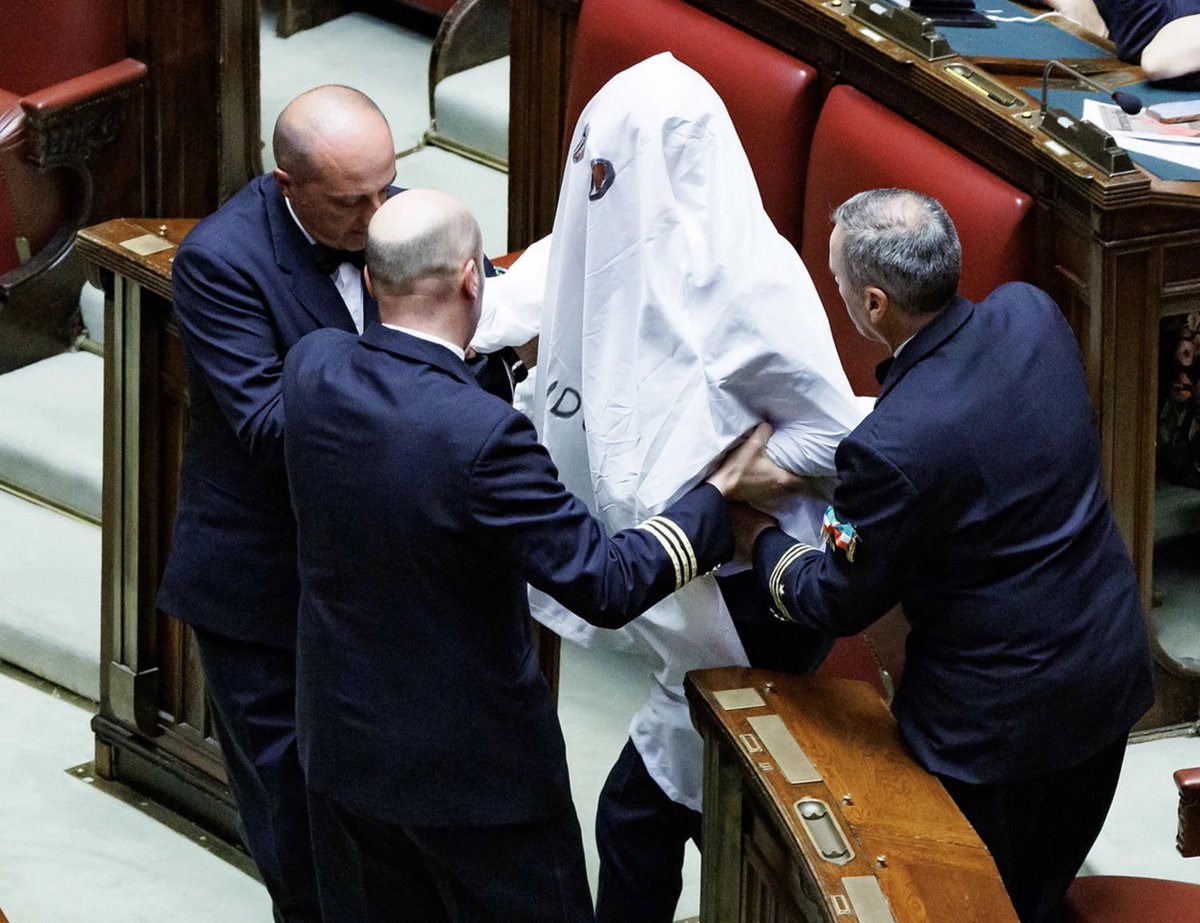 Marcolisei's tweet photo. Il livello della sinistra in Italia. 
Il deputato Magi si è presentato alla Camera vestito da fantasma. Dopo Bonelli con i sassi dell'Adige, Soumahoro con gli stivali, Fornaro che piange per Ventotene, il Pd con i cartelli. 
Riducono le istituzioni che vorrebbero guidare ad una parata di carnevale.
Per fortuna che c'è Giorgia Meloni a tenere in piedi l'Italia.