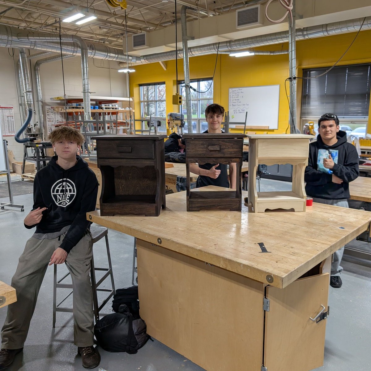 Two thumbs up for craftsmanship! 🎉  Mr. Germain's Craftsmanship students proudly showcase their beautifully crafted nightstands! 🛠️✨  #hustlinhawks #hawksflyhigh #CraftsmanshipClass #HandmadeSuccess