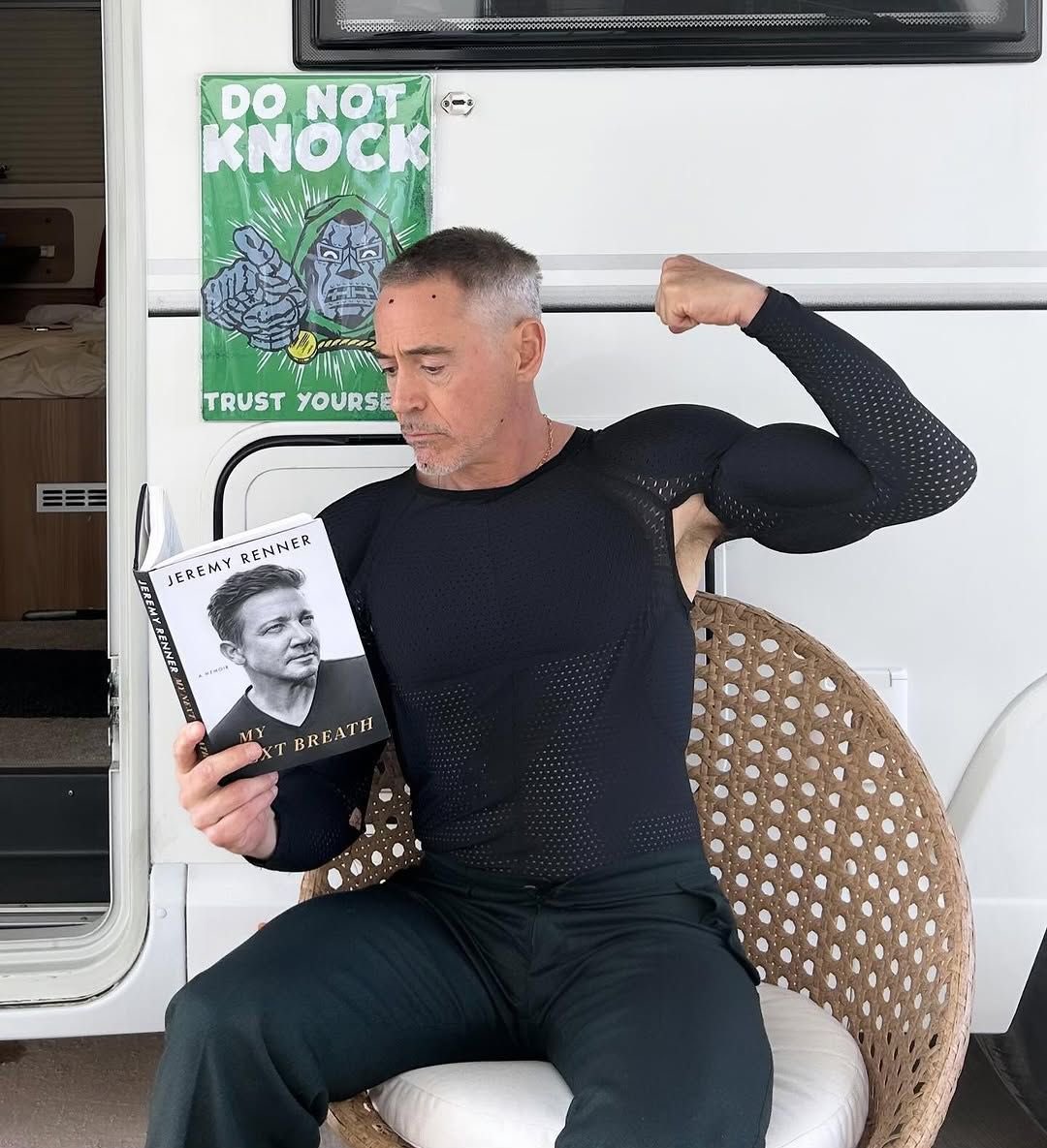 Robert Downey Jr., once MCU’s Tony Stark, gears up to play Doctor Doom in Avengers: Doomsday (May 1, 2026), marking a bold hero-to-villain shift, as Marvel announced in July 2024. 📽️ Spotted holding Jeremy Renner’s memoir My Next Breath—about Renner’s recovery from a near-fatal