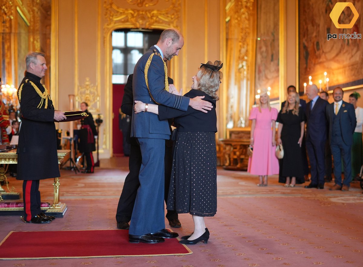 Wendy Daunt, a Deaf Studies Teacher at the Royal School for the Deaf, in Derby, receives a big hug from Prince William after being presented with an OBE at Windsor Castle. The honour recognised her services to deaf children and to the young adult and deaf communities. #Royal